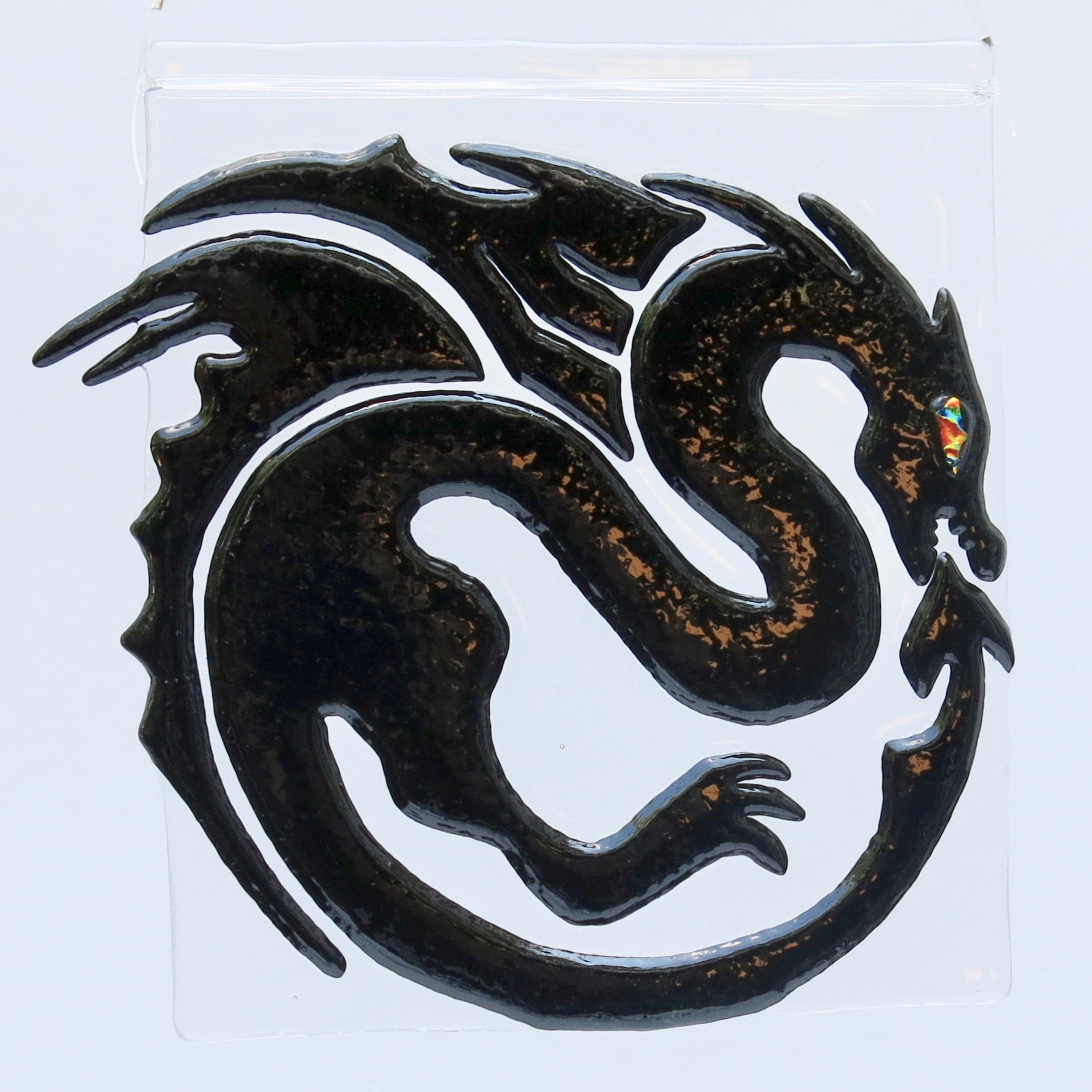 This fused glass black dragon has a dichroic eye and measures 7" x 7" (18 cm x 18 cm)