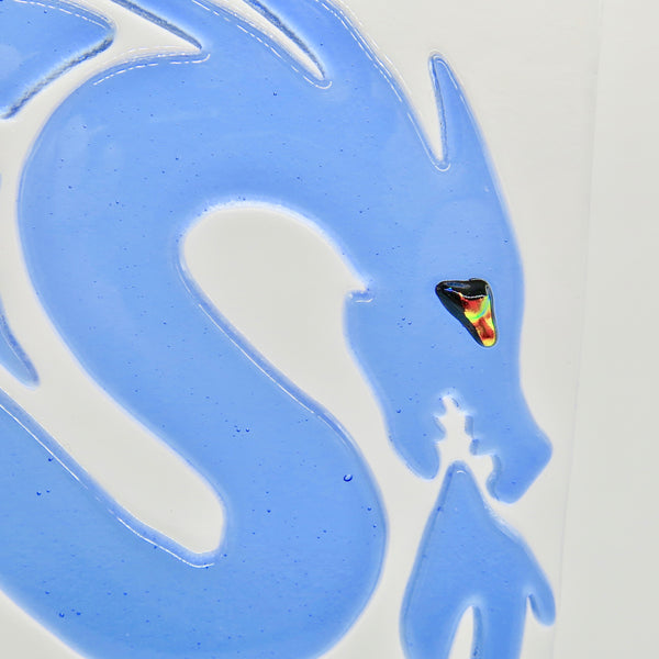 This fused glass blue dragon has a dichroic eye and measures 7" x 7" (18 cm x 18 cm), close up of head/eye